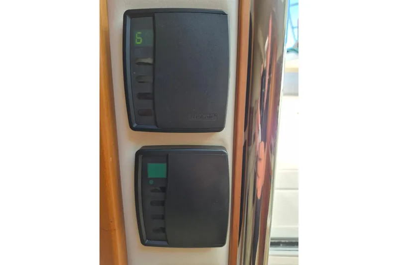 Slide: The Image of Control panel on a 2004 Riviera 4000 Offshore yacht, featuring digital displays. - 67