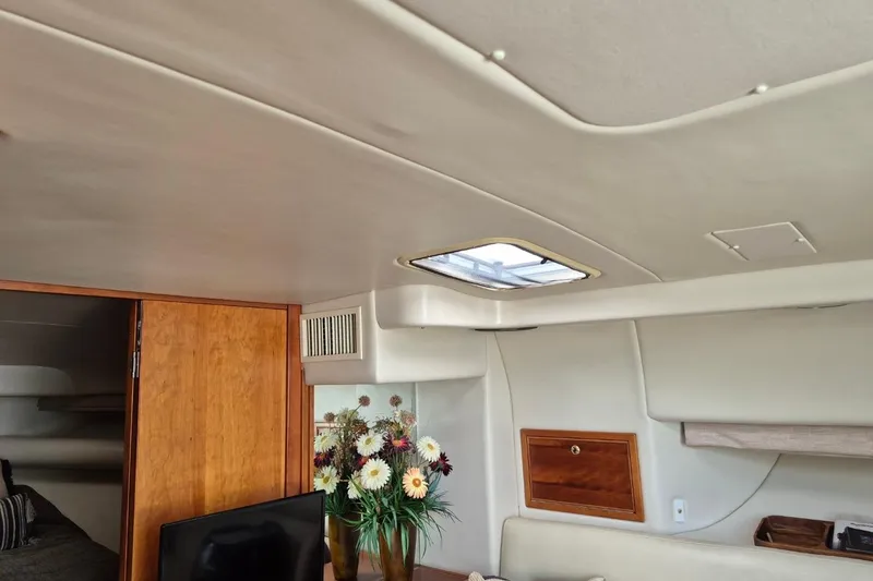 Slide: The Image of Interior of 2004 Riviera 4000 Offshore yacht with skylight and floral arrangement. - 70