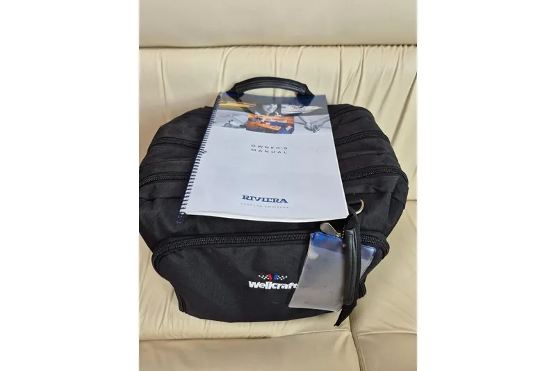 Slide: The Image of Black Wellcraft bag with 2004 Riviera 4000 Offshore owner's manual on top. - 71