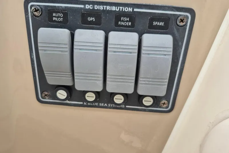 Slide: The Image of Control panel on 2004 Riviera 4000 Offshore boat with autopilot, GPS, and fish finder switches. - 72