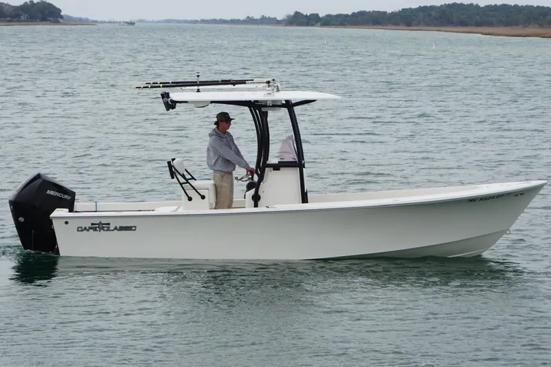 Slide: The Image of 2020 May-Craft 23 Cape Classic boat on water, side view with driver. - 4