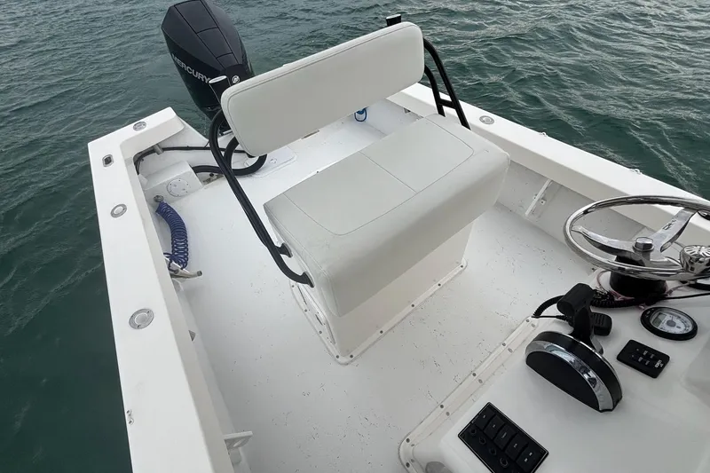 Slide: The Image of 2020 May-Craft 23 Cape Classic boat interior with steering wheel and seating. - 8