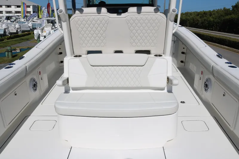 Slide: The Image of 2026 World Cat 325 CC boat interior with white cushioned seating and diamond stitching. - 10