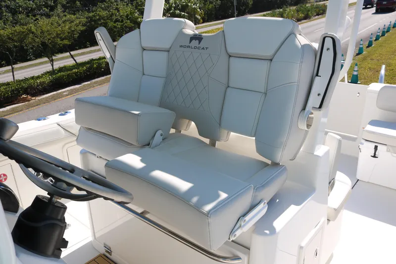 Slide: The Image of 2026 World Cat 325 CC boat with luxurious white seating and steering wheel. - 13