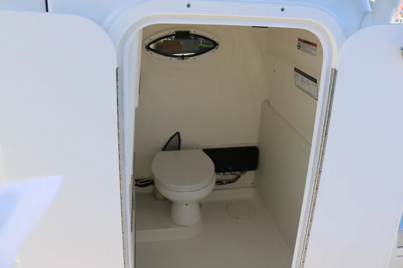 Slide: The Image of Interior view of 2026 World Cat 325 CC boat's compact bathroom. - 14