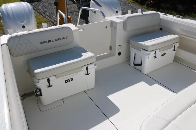 Slide: The Image of 2026 World Cat 325 CC boat interior with Yeti coolers and cushioned seating. - 15