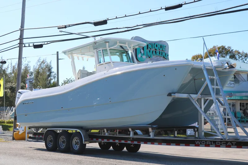 Slide: The Image of 2026 World Cat 325 CC boat on trailer at Unique Marine dealership. - 3