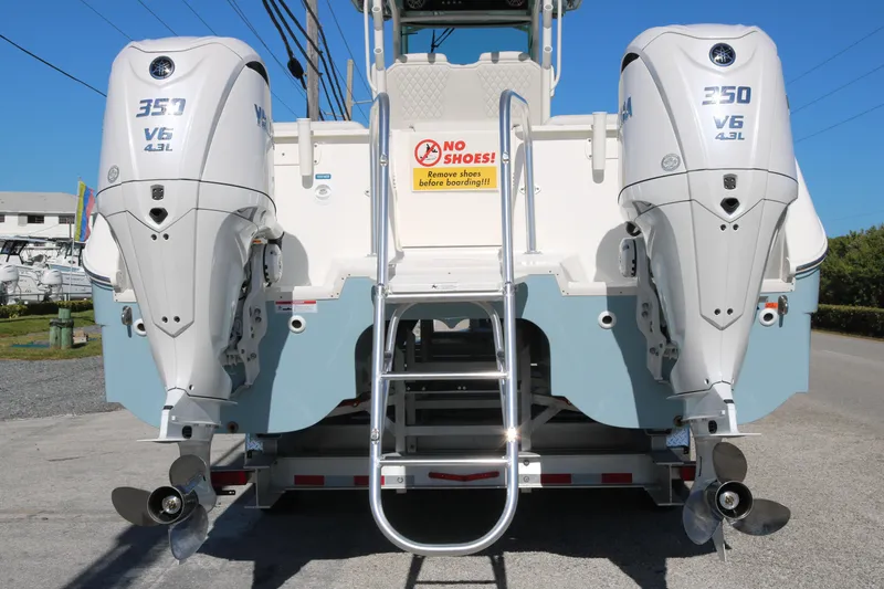 Slide: The Image of 2026 World Cat 325 CC boat with twin 350 V6 engines, rear view. - 5