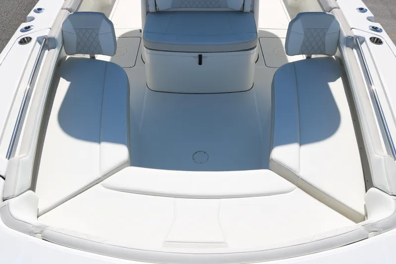 Slide: The Image of 2026 World Cat 325 CC boat interior with white cushioned seating and sleek design. - 8