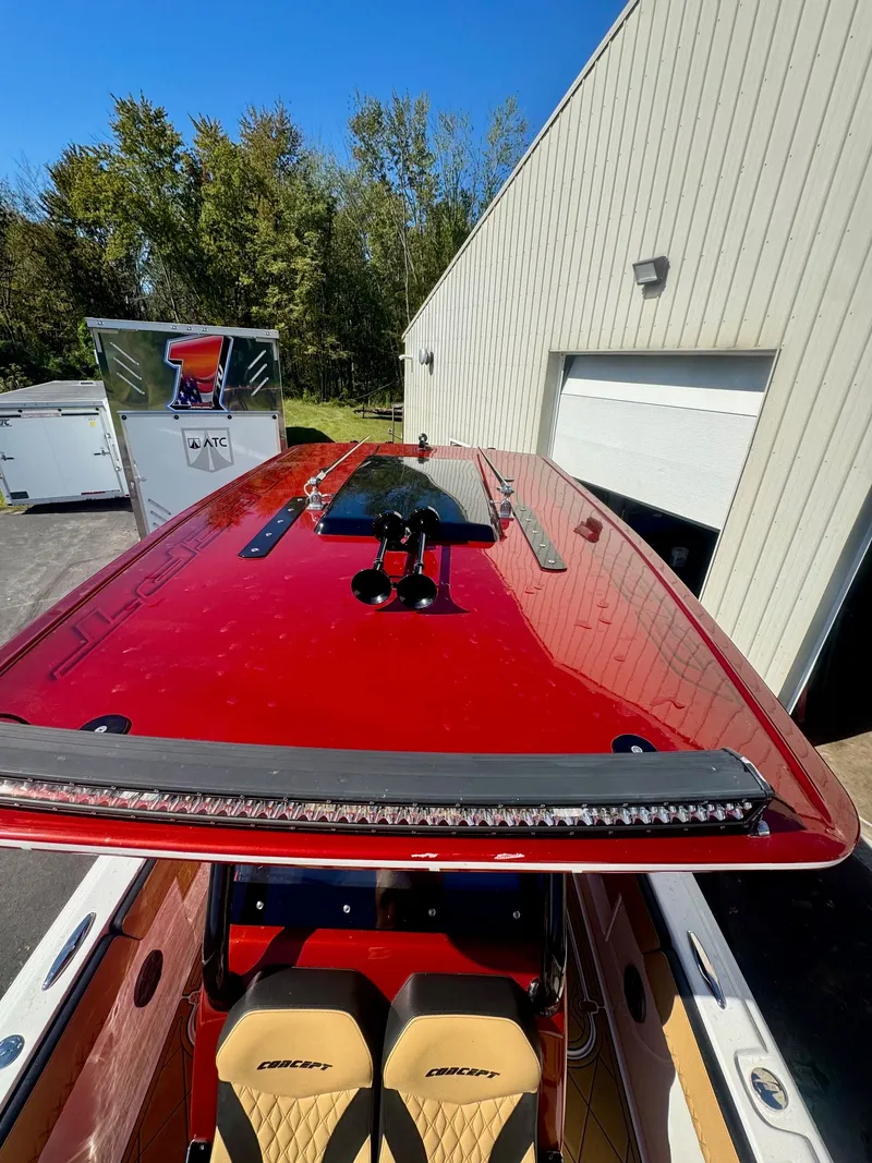 Slide: The Image of Red 2019 Concept 36' Open Deck boat outside garage. - 13