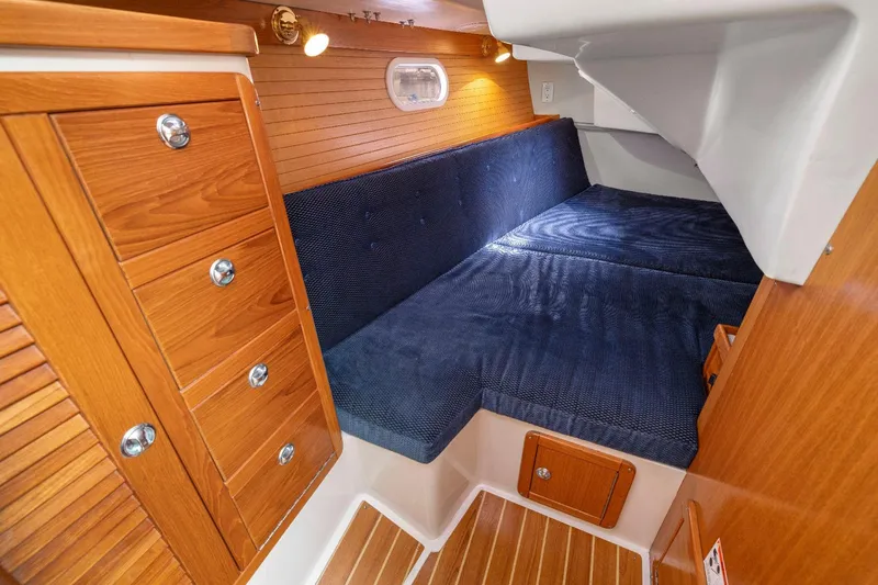 Slide: The Image of Cozy cabin interior of 2004 Catalina 36 MkII with wood paneling and blue upholstery. - 10