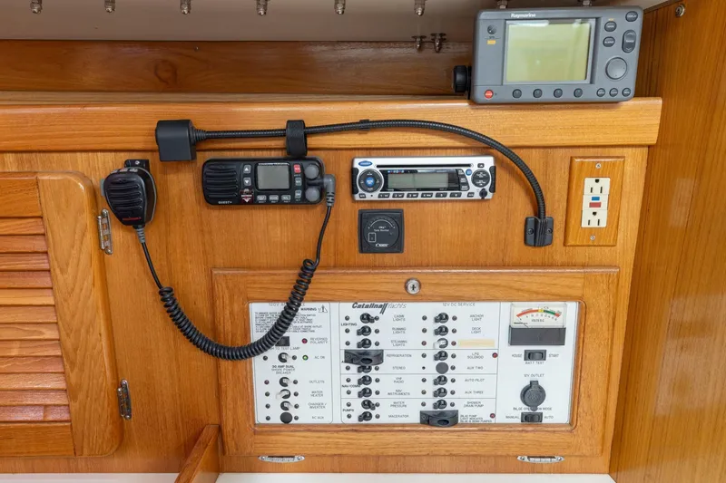 Slide: The Image of Control panel of a 2004 Catalina 36 MkII sailboat with navigation and communication equipment. - 12