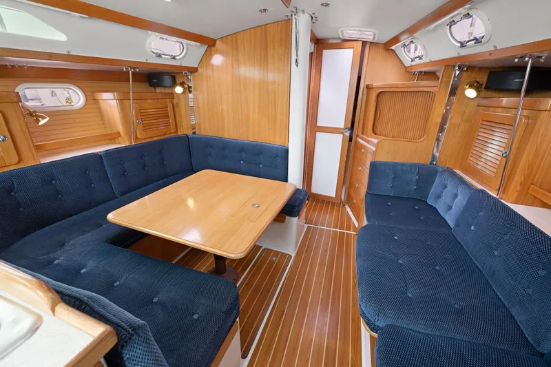 Slide: The Image of Interior of 2004 Catalina 36 MkII sailboat with blue seating and wooden accents. - 13