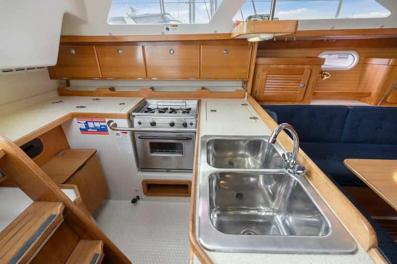 Slide: The Image of 2004 Catalina 36 MkII yacht interior with kitchen, stove, and double sink. - 14