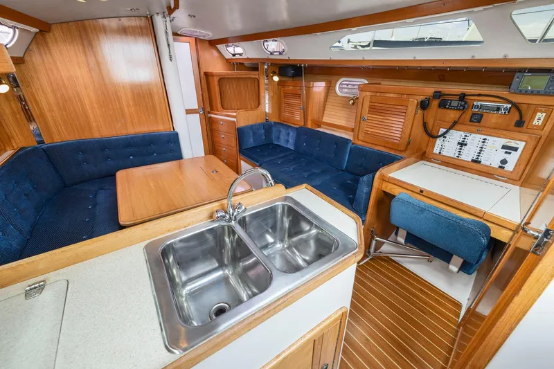 Slide: The Image of Interior of a 2004 Catalina 36 MkII sailboat with wood finish and blue seating. - 16