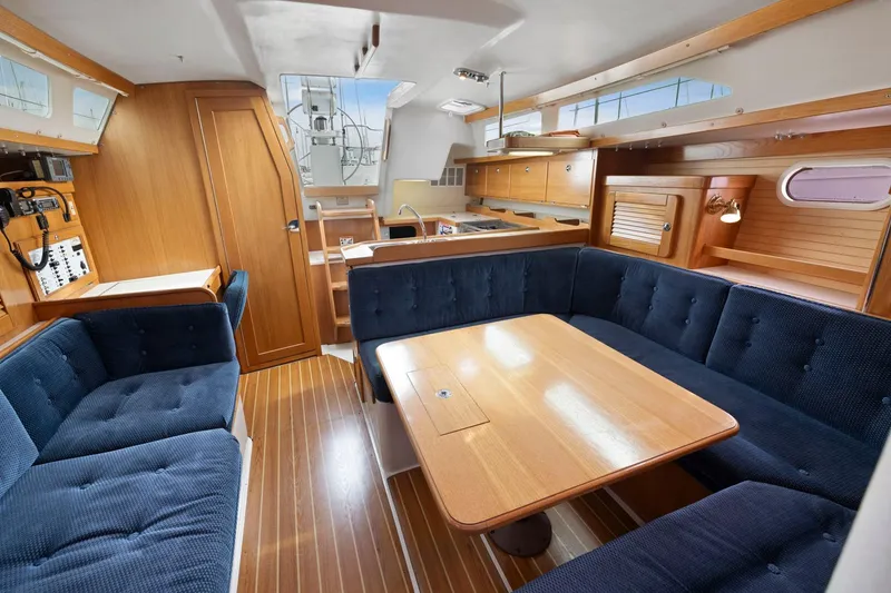 Slide: The Image of Interior of 2004 Catalina 36 MkII sailboat with wooden furnishings and blue seating. - 18