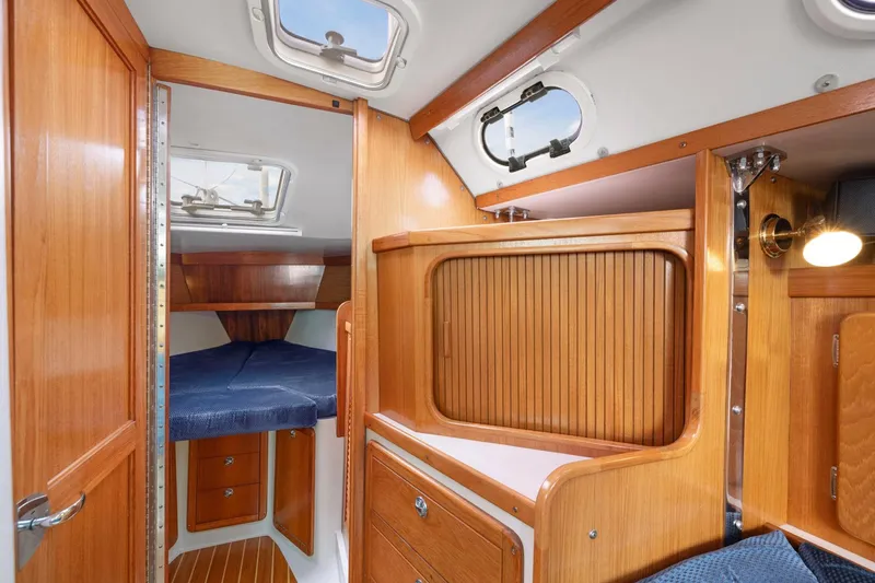 Slide: The Image of Interior of 2004 Catalina 36 MkII sailboat with wooden cabinetry and cozy sleeping area. - 19