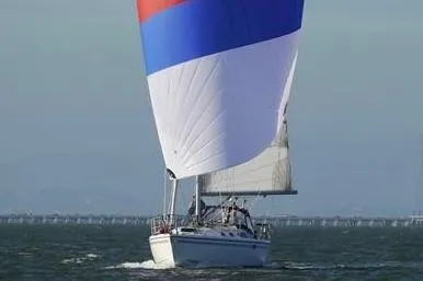 Slide: The Image of 2004 Catalina 36 MkII sailboat with colorful spinnaker on open water. - 2