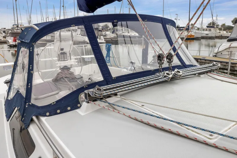 Slide: The Image of 2004 Catalina 36 MkII sailboat with blue canvas cover in marina setting. - 25