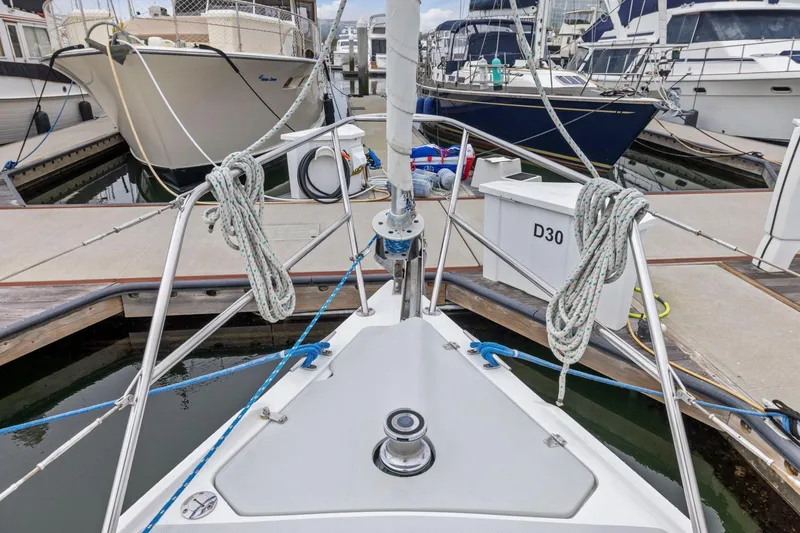 Slide: The Image of Bow of 2004 Catalina 36 MkII sailboat docked at marina, surrounded by other boats. - 26