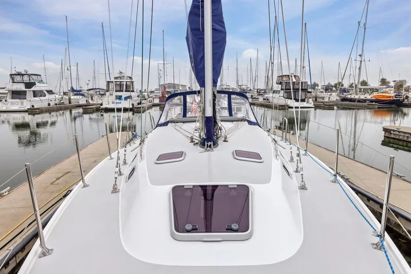 Slide: The Image of 2004 Catalina 36 MkII sailboat docked in a marina, surrounded by other boats. - 27