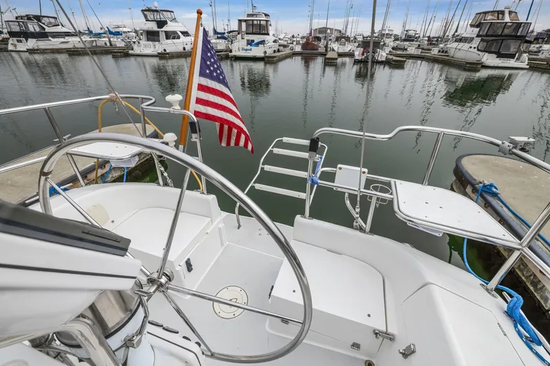 Slide: The Image of Cockpit view of 2004 Catalina 36 MkII sailboat docked in marina with American flag. - 30