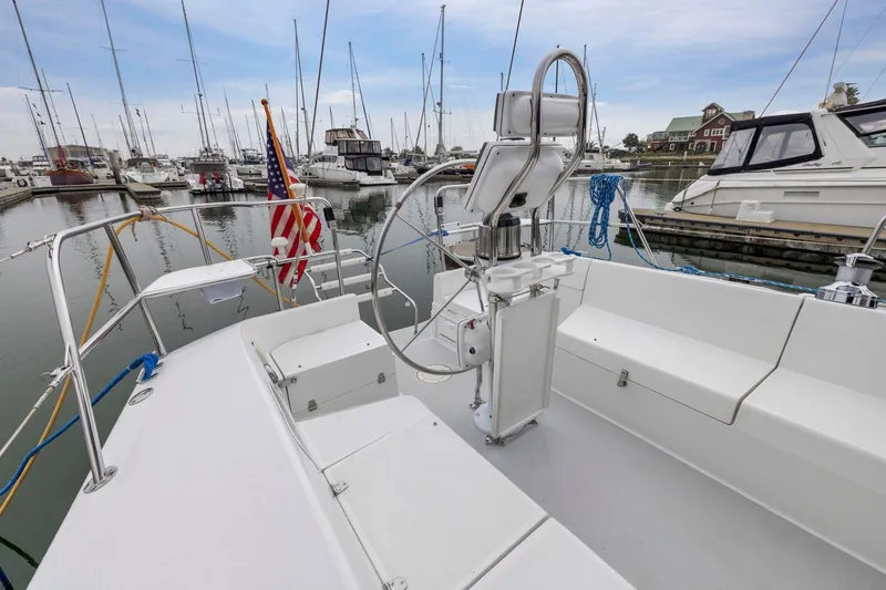 Slide: The Image of 2004 Catalina 36 MkII sailboat cockpit in marina, featuring helm and seating area. - 32