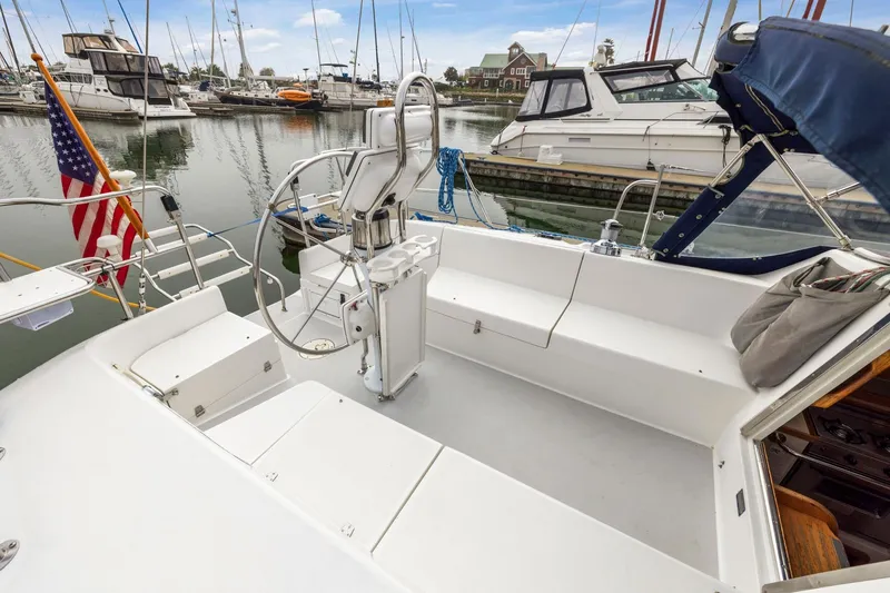 Slide: The Image of 2004 Catalina 36 MkII sailboat cockpit with steering wheel, docked in marina. - 34