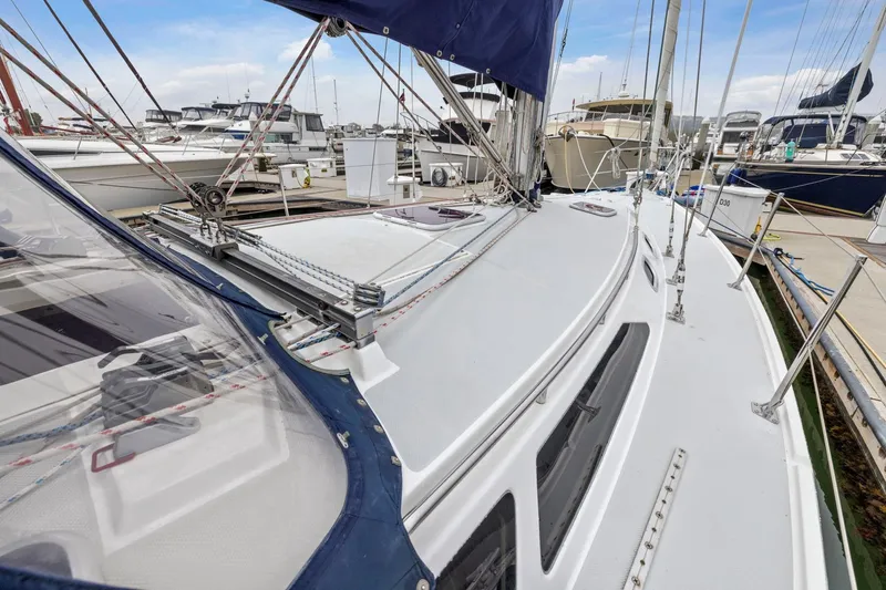 Slide: The Image of 2004 Catalina 36 MkII sailboat docked at marina, showcasing deck and rigging. - 42