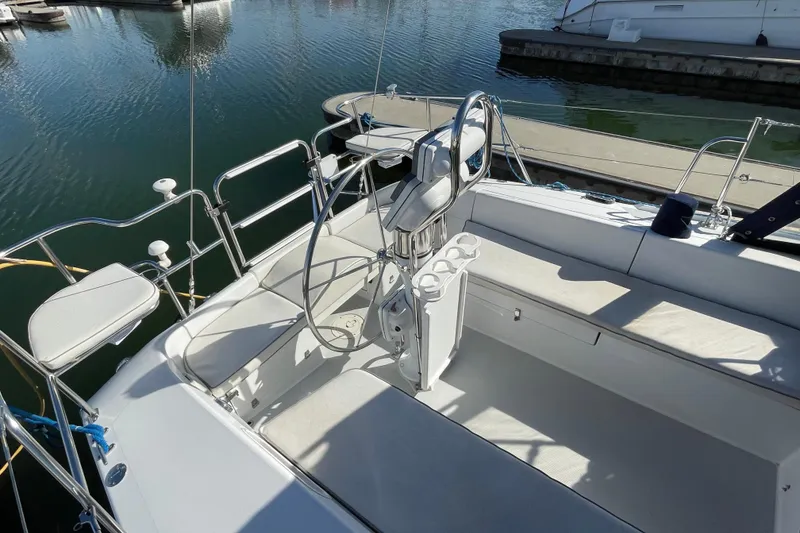 Slide: The Image of 2004 Catalina 36 MkII sailboat cockpit with steering wheel and seating, docked at marina. - 49