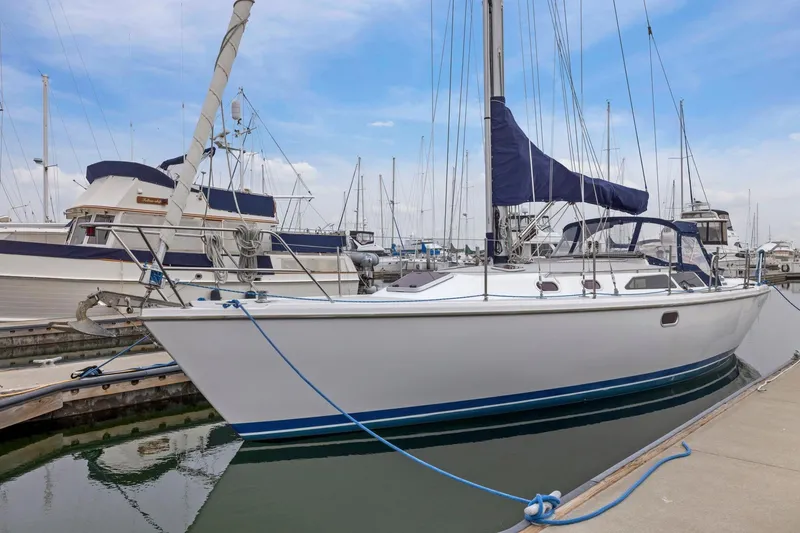 Slide: The Image of 2004 Catalina 36 MkII sailboat docked at marina, featuring sleek design and blue accents. - 5