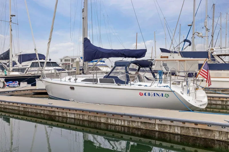 Slide: The Image of 2004 Catalina 36 MkII sailboat docked at marina, featuring "Ohana" name and American flag. - 9