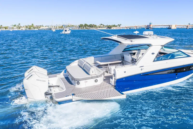 Slide: The Image of 2023 Sea Ray SLX 400 Outboard cruising on blue ocean waters. - 18