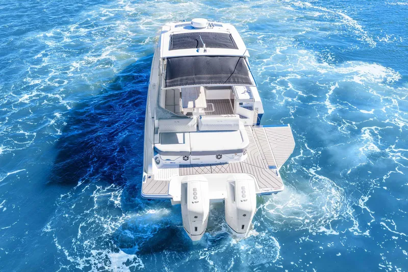 Slide: The Image of 2023 Sea Ray SLX 400 Outboard cruising on vibrant blue ocean waters. - 20