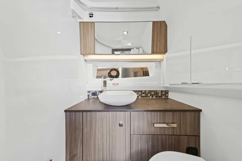 Slide: The Image of Luxurious bathroom interior of 2023 Sea Ray SLX 400 Outboard yacht, featuring modern sink and cabinetry. - 43
