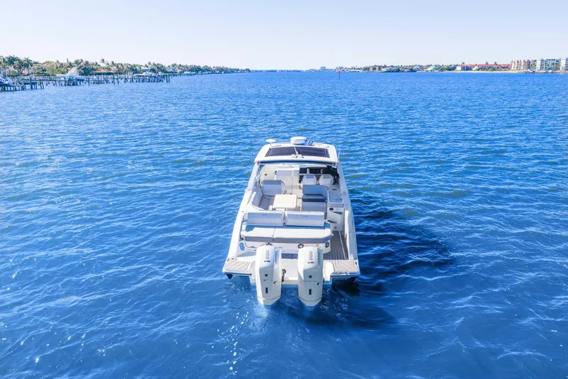 Slide: The Image of 2023 Sea Ray SLX 400 Outboard cruising on clear blue water. - 6