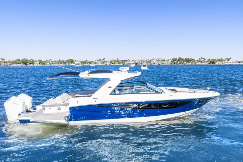 The Image of 2023 Sea Ray SLX 400 Outboard cruising on a sunny day, blue water background. - 0