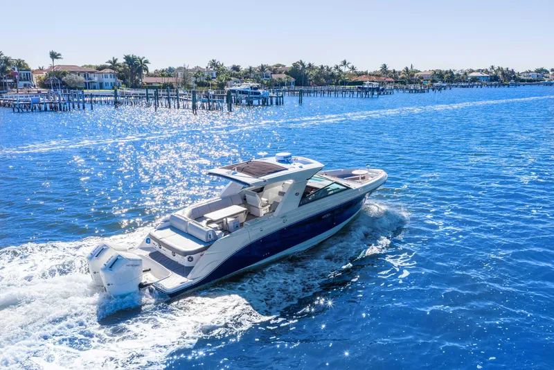 Slide: The Image of 2023 Sea Ray SLX 400 Outboard cruising on a sunny, sparkling blue waterway. - 10