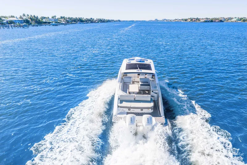 Slide: The Image of 2023 Sea Ray SLX 400 Outboard cruising on open blue water. - 13