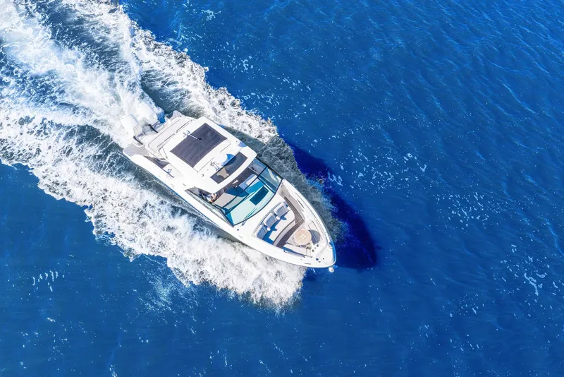Slide: The Image of 2023 Sea Ray SLX 400 Outboard cruising on vibrant blue ocean waters. - 16