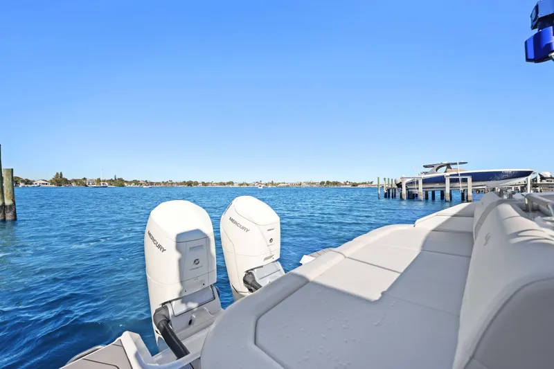 Slide: The Image of 2023 Sea Ray SLX 400 Outboard on serene blue water, showcasing dual Mercury engines. - 26