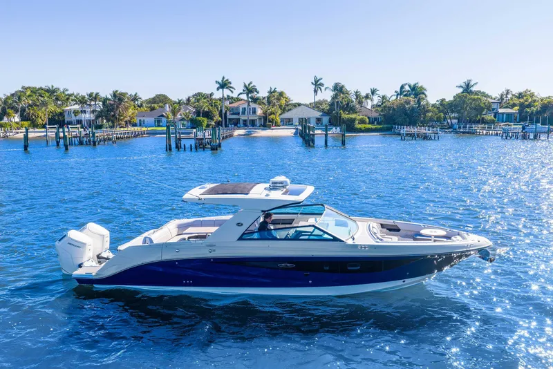 Slide: The Image of 2023 Sea Ray SLX 400 Outboard cruising on a sunny, blue waterway. - 3