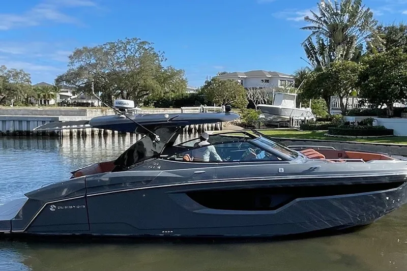 The Image of 2023 Cruisers Yachts 380 Express on calm water near dock. - 0
