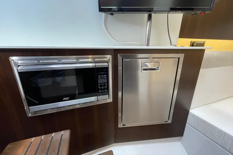 Slide: The Image of 2023 Cruisers Yachts 38 GLS I/O interior with microwave and stainless steel appliance. - 12
