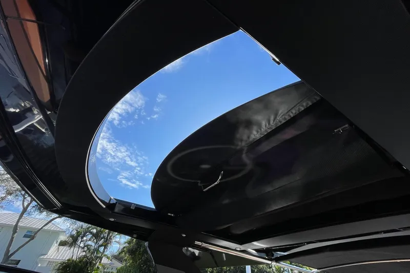 Slide: The Image of 2023 Cruisers Yachts 38 GLS I/O sunroof view with clear blue sky. - 13