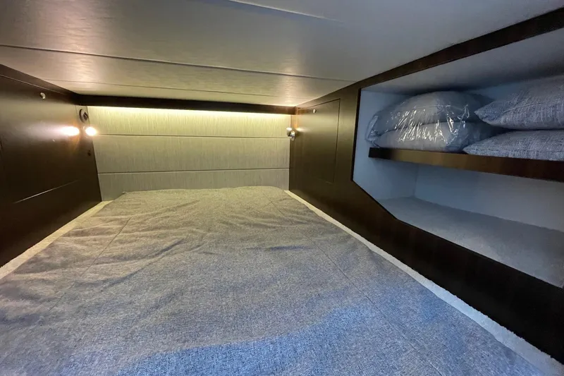Slide: The Image of 2023 Cruisers Yachts 38 GLS I/O cabin interior with bed and shelves. - 20