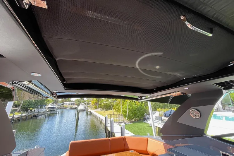 Slide: The Image of 2023 Cruisers Yachts 38 GLS I/O interior with retractable roof and waterfront view. - 31