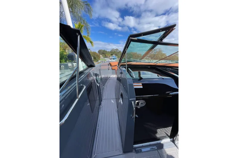 Slide: The Image of 2023 Cruisers Yachts 38 GLS I/O deck with open glass doors under blue sky. - 32