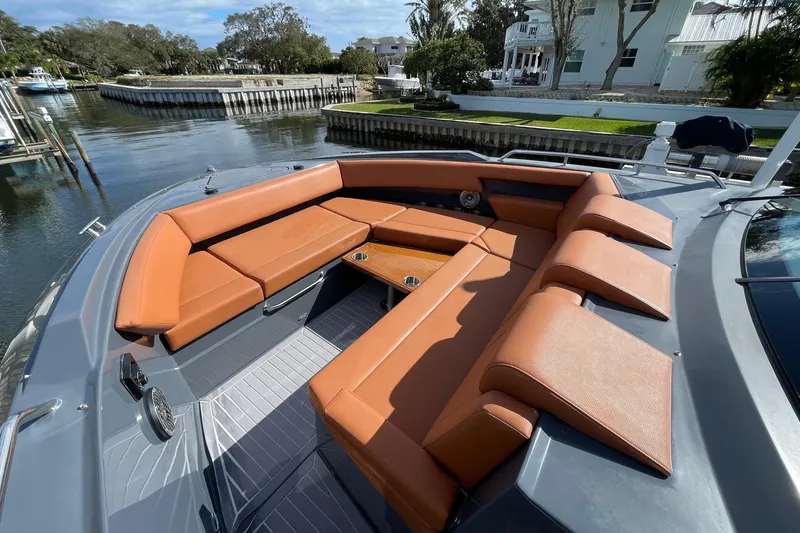 Slide: The Image of 2023 Cruisers Yachts 38 GLS I/O with luxurious seating on a serene waterfront. - 33