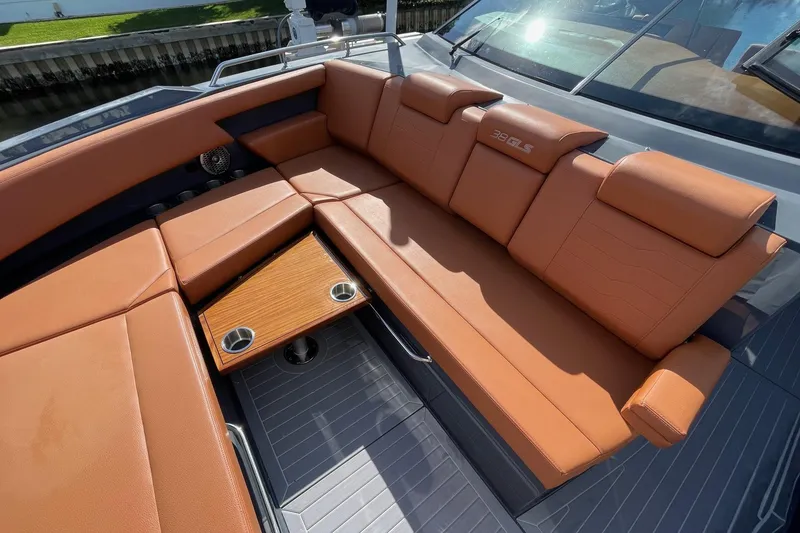 Slide: The Image of 2023 Cruisers Yachts 38 GLS I/O with luxurious tan seating and integrated cup holders. - 34